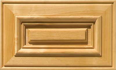 Prudential raised panel drawer front with routed outer edge and applied molding around the center panel