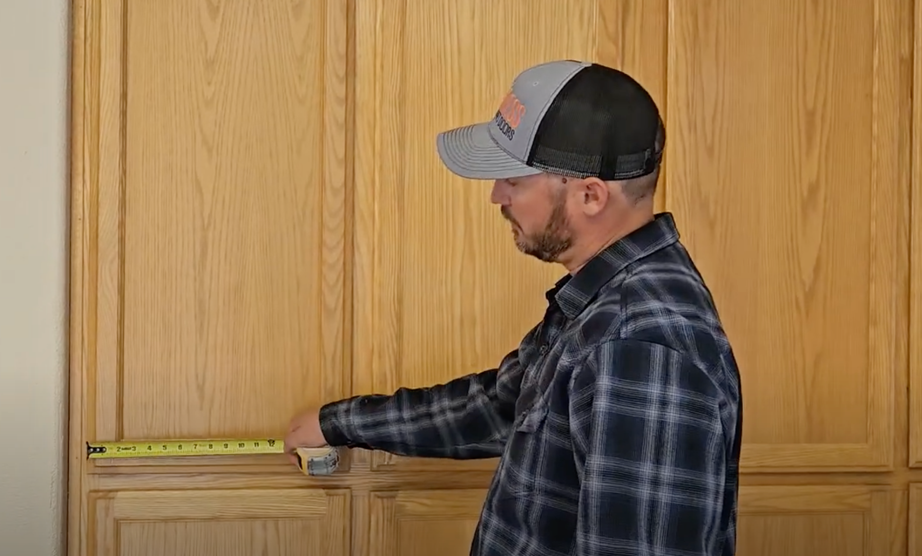 contractor measuring cabinet doors to determine the size for replacement cabinet doors