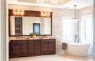 Remodeled bathroom featuring Harmony cabinet doors in dark brown natural wood.